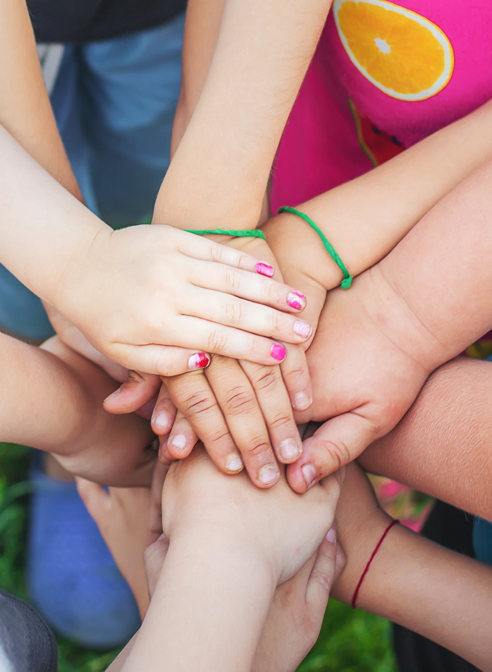 Smiling child with colorful painted hands